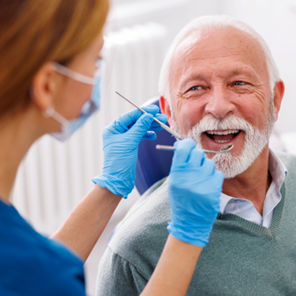 Man smiles at dentist