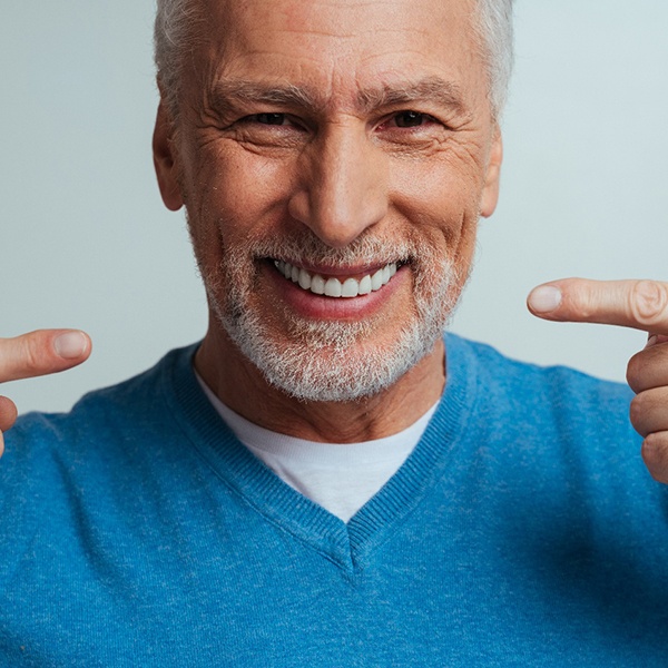 A smiling man wearing dentures