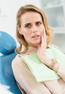 Woman holding cheek in pain