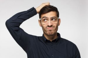 Confused man scratching his head