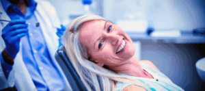 a patient smiling while visiting their dentist