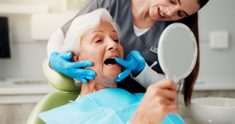 A dentist showing a patient her dental implant