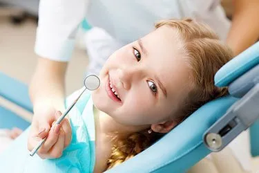 Photo of a smiling child getting her teeth checked at Main Line Dental Group in Wayne PA